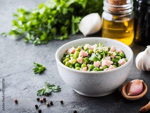 Sauteed peas with ham and fresh herbs in a bowl
