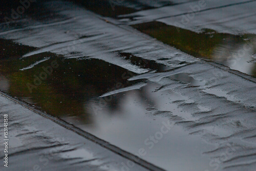 Fotografie The dry wooden floor is now transformed, covered with shimmering water reflectin