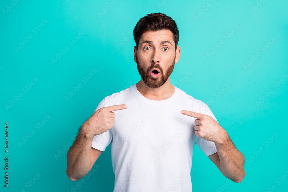 Surprised young man in white t-shirt makes gestures on turquoise background Surprised young man in white t-shirt makes gestures on turquoise background