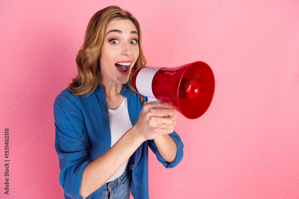 Lovely woman holding a megaphone against a pink background conveys energy and enthusiasm for communication and marketing activities Lovely woman holding a megaphone against a pink background conveys energy and enthusiasm for communication and marketing activities