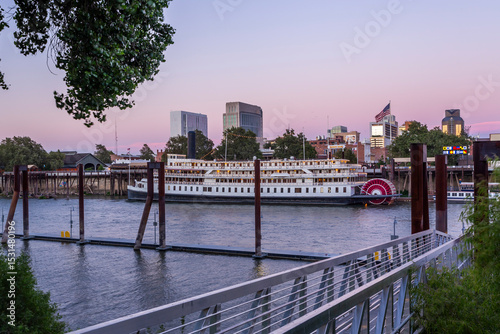 Sacramento River in city area. Vessel and cityscape in twilight in Sacramento, California