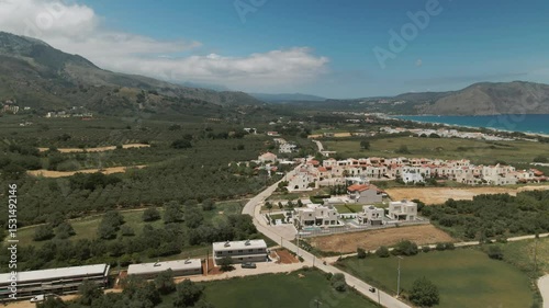 Elevated view of residential development, olive groves and coastline extending along the sea near the Asprouliani region in Crete, Greece