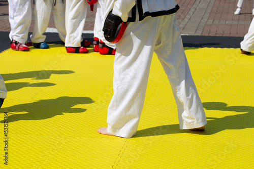 People practice taekwondo on the street. Outdoor exercise.