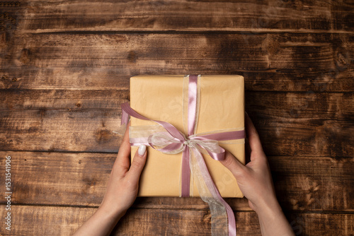 woman  hands put gift box on table.