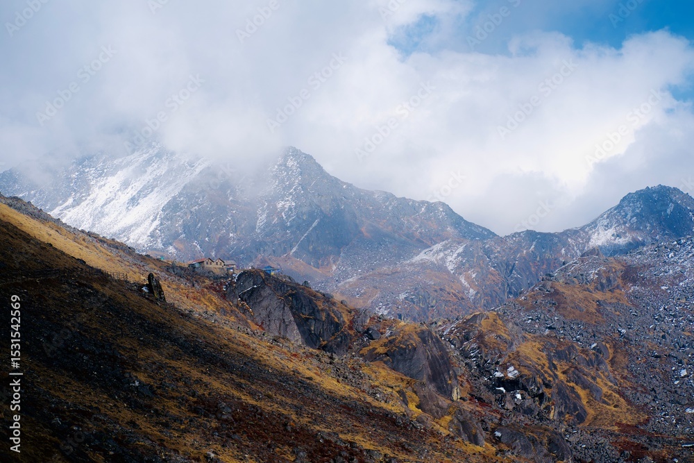 Fototapeta premium Himalayan high mountain landscape with dramatic clouds and snow background