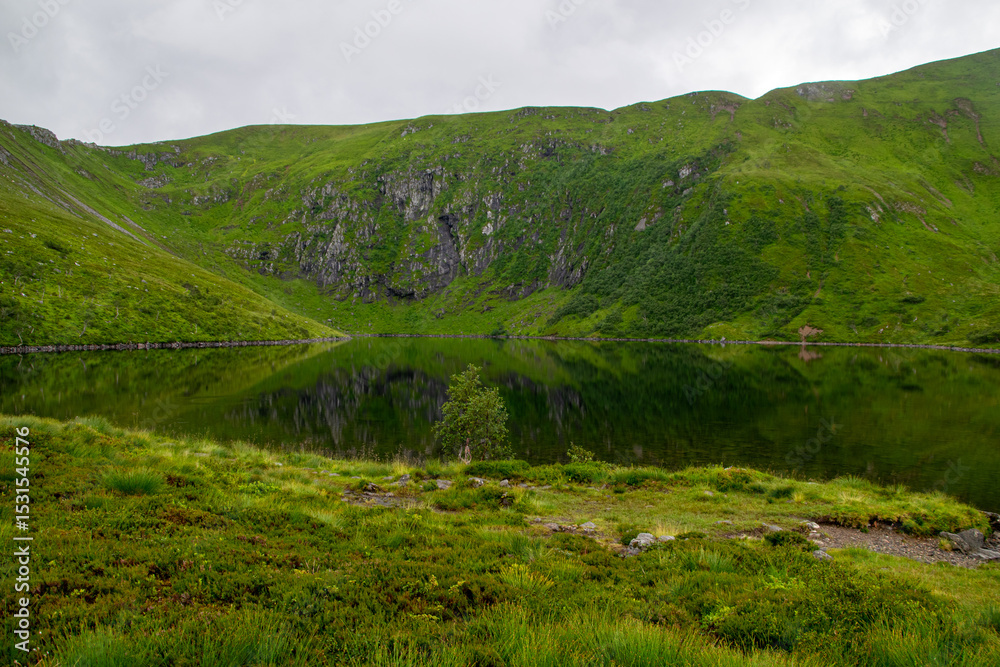 Fototapeta premium Peaceful Mountain Lake Reflection at Skottenvannet on the Trail to Sjurvarden, Norway