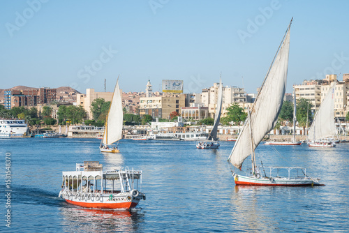 A large sailed sailboat is gracefully floating on the water, Aswan, Egypt