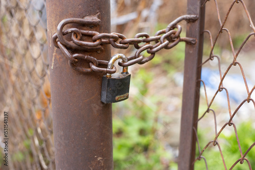 A old farm gate locked with rusty old chains