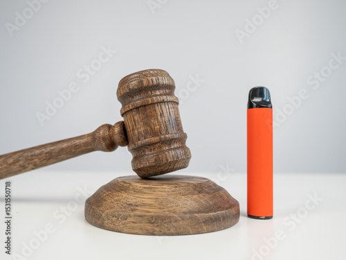 Judge's gavel and e-cigarette. Smoking ban. Tobacco heating systems. 