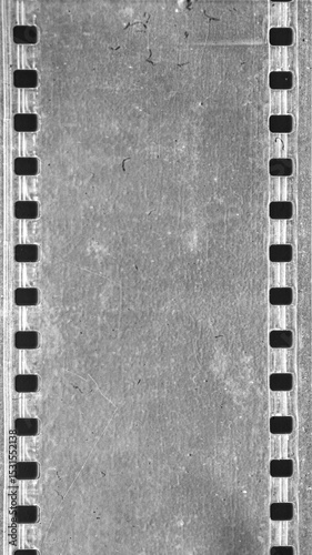 Vintage film strip with sprocket holes on textured gray background