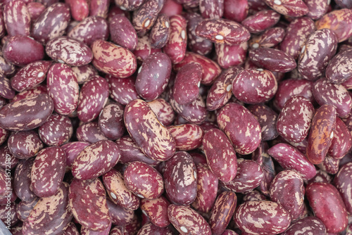Top view of dried red beans with white spots, close-up, background for product design in the store on a market stall at a farmer's fair.