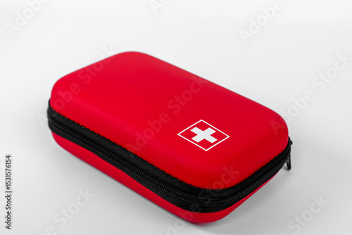 Red protective case with a white cross symbol resting against a plain background highlighting its design and functionality