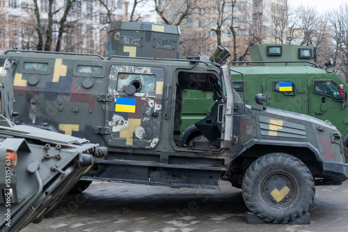 Military vehicles on display in urban area showcasing defense capabilities with Ukrainian flags