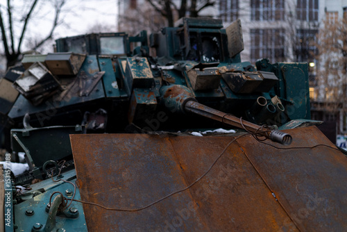 Rusty military vehicle on city street with winter setting in urban area during overcast day