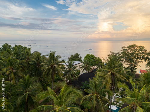 Tropical palm trees on a beach at sunset, Gili Air, Lombok, Indonesia photo