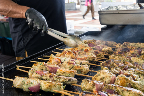 shish kebab on the barbecue with man's hand moving it