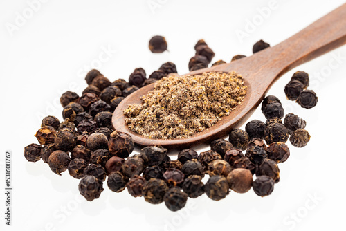 Fototapeta Naklejka Na Ścianę i Meble -  Black peppercorns in a wooden spoon - Piper nigrum