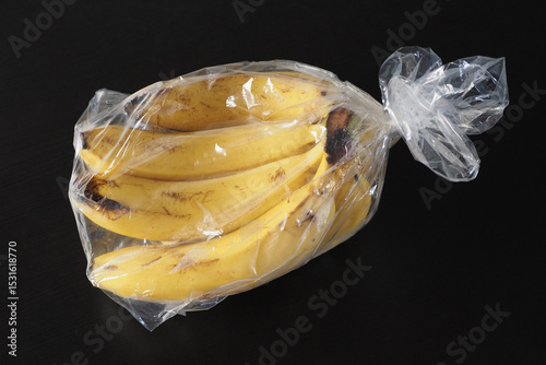 Yellow ripe fresh bananas from Dominican Republic in transparent plastic bag. 