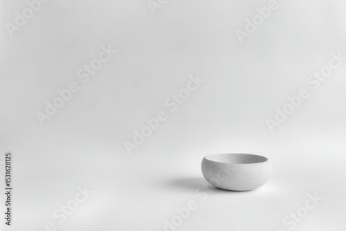 delicate monochrome still life featuring single ceramic object on clean ultrabright background