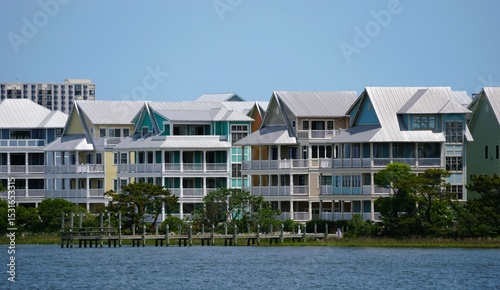 Colorful waterfront homes line the tranquil waterway, showcasing a vibrant coastal community along Assawoman Bay, Ocean City, Maryland, U.S.A