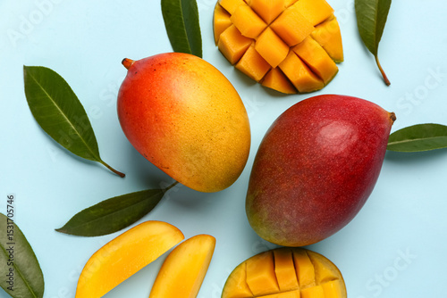 Fresh ripe mangoes on light...