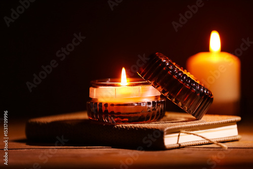 Book with burning candles o...