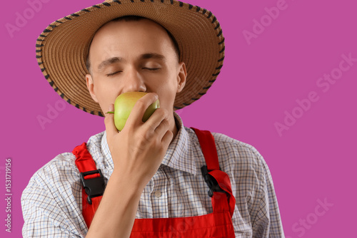 Young farmer eating tasty a...