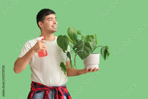 Young man with plant and sp...