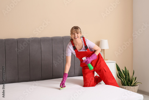 Female janitor cleaning mat...