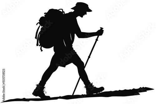 Silhouette of a hiker trekking with a backpack and walking sticks