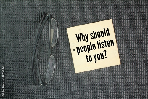 Glasses and wood with the question word Why should people listen to you?