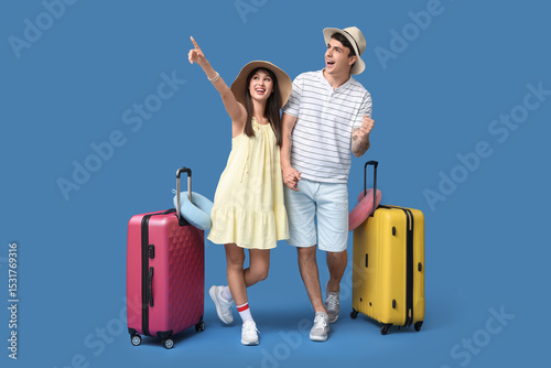 Couple of tourists with sui...