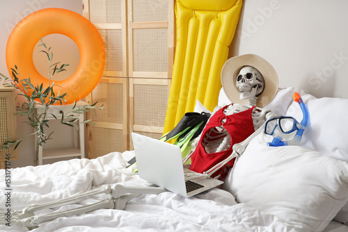 Human skeleton with laptop ...