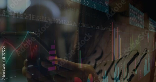 Finance analyst tapping phone driving transparent display showing bar and line charts for review