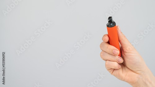 Woman holding disposable vape on white background. Copy space. 