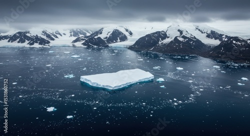Antarctic icebergs and mountain range aerial view