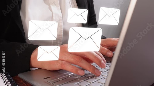 A person typing on their laptop, with white envelopes floating above the keyboard and visible in front of them as if they were icons or symbols representing messages being sent via email. 