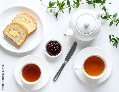 Elegant tea setup with slices of bread and jam, perfect for a cozy afternoon.