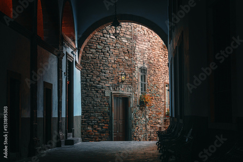 Colonial Courtyard Arch Weathered Stone Wall and wood doors in Guanajuato Mexico, atmospheric Alley in an Old mexican Town with cinematic Lighting