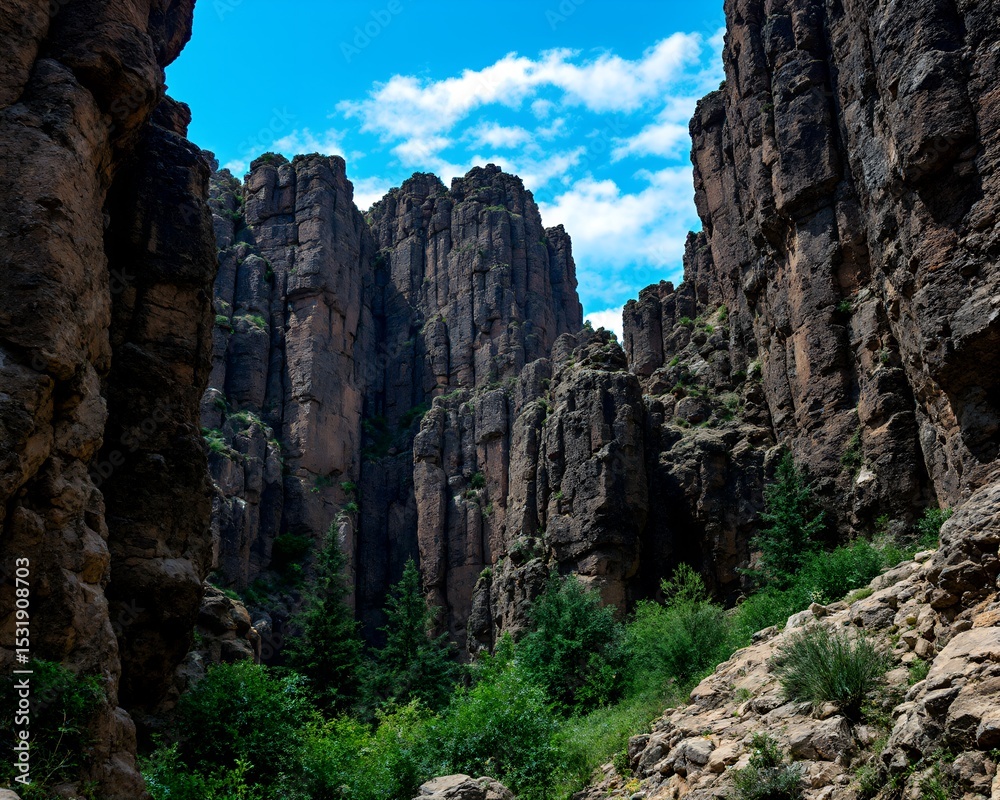 Obraz premium Blocky Cliffs Landscape Under Clear Blue Sky – Nature Rock Formation Illustration