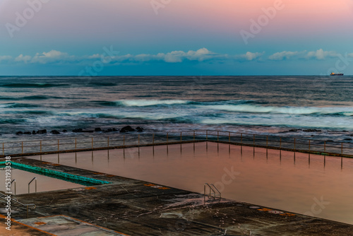Sunset at the Seaside with black rocks photo