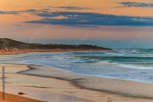 Sunset at the Seaside with black rocks photo
