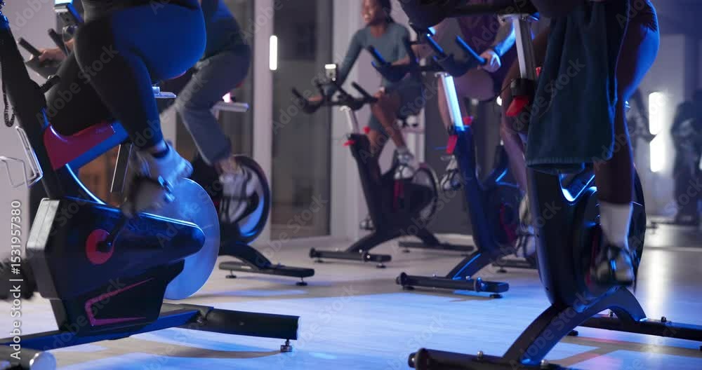 Fast, cycling and legs with bike, gym and performance for group with machine, wellness and training. Cardio, ride and people with equipment for fitness, healthy and energy for spin class or exercise