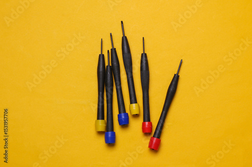 Set of collet screwdrivers on yellow background