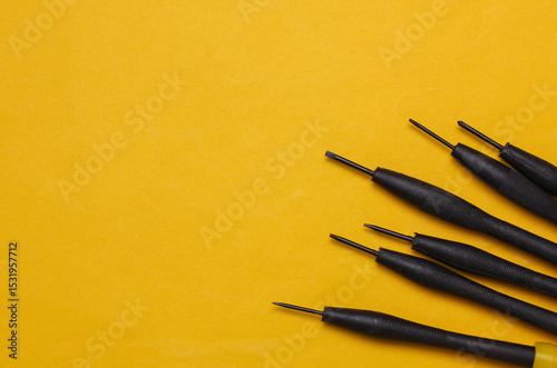 Set of collet screwdrivers on yellow background