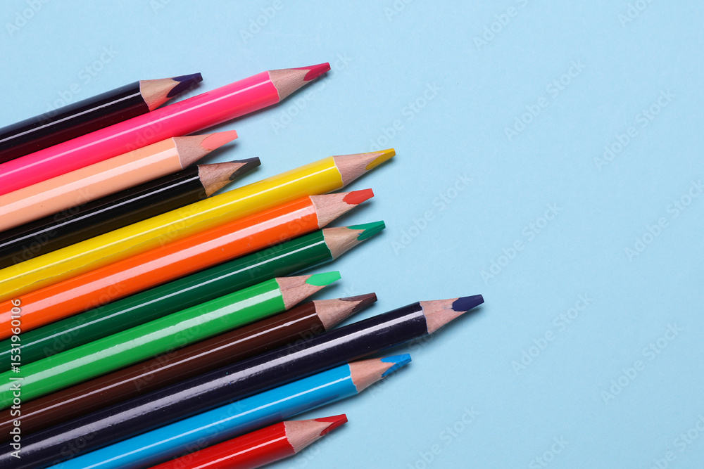 Fototapeta premium Set of wooden colored pencils on blue background