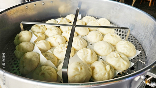 Steaming Delight: An alluring assortment of freshly steamed buns nestled within a traditional steamer. A culinary experience. capturing warmth and delicious aroma.