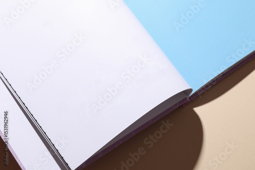 Blank page of open book or magazine on a beige background. Mockup for design