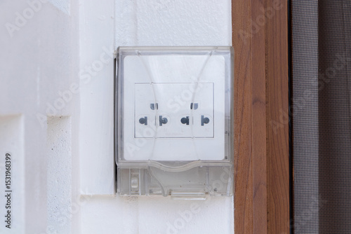 Box white electrical power switch off, on and plug energy with plastic pipe wiring. Covered with clear plastic attached to concrete wall. Turning Off Light switch. Electrical safety technology.