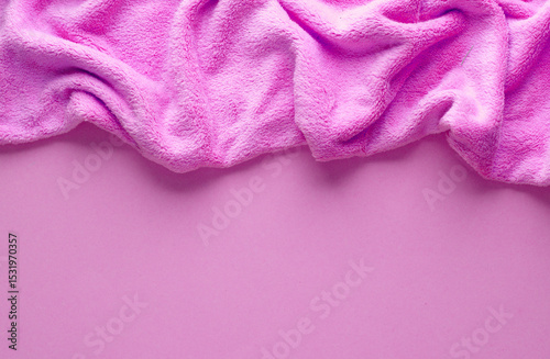 Crumpled pink fleecy fabric on pink background, copy space